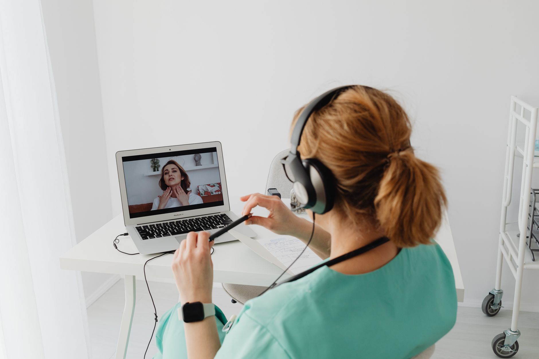 Nurse practitioner evaluating a patient during a telehealth urgent care video visit